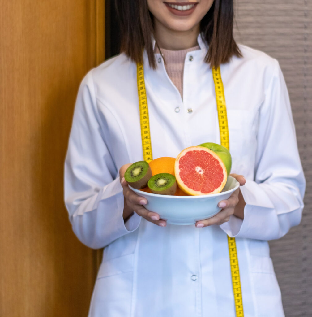 nutritionist holding bowl mixed fruit